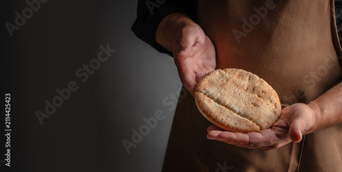 Baker Holding Fresh Pita Bread with Copy Space