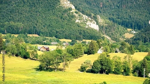 French alpine farm and green mountain valley seen from a moving car