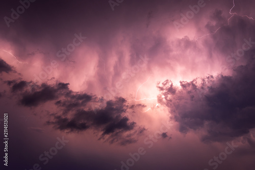 Obraz na płótnie Thunderstorm, discharges in the night sky, clouds illuminated by a flash