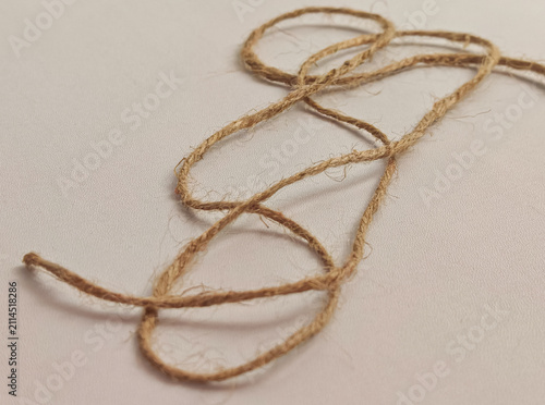 Cuadro en lienzo Natural jute twine rope arranged on a white background showing organic fiber tex