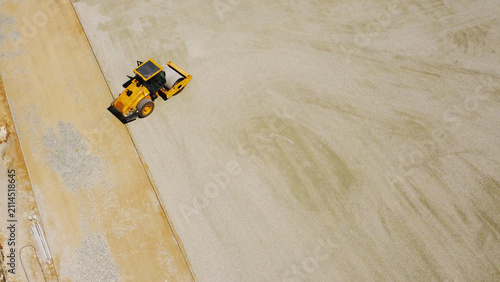 Aerial Top View of Road Roller Compacting Gravel Base