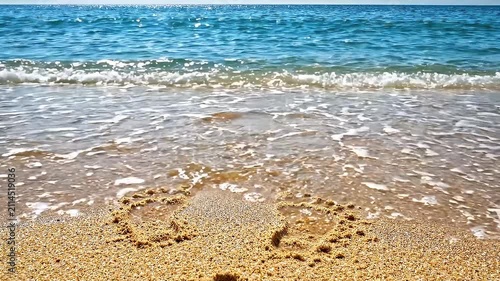 Romantic Heart Shape Drawn in Golden Sand on a Sunny Tropical Beach with Gentle Ocean Waves