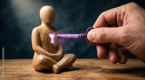 Hand unlocking human potential with a key. Personal growth and self-improvement concept.