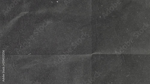 Abstract dark gray grunge paper texture with subtle folds and vintage paper grain overlay.
