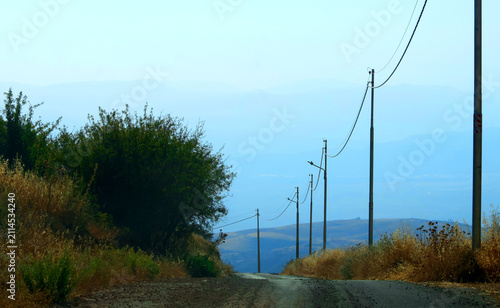 Electricity poles on the side of a secondary road in the mountains surrounding the capital, Amman