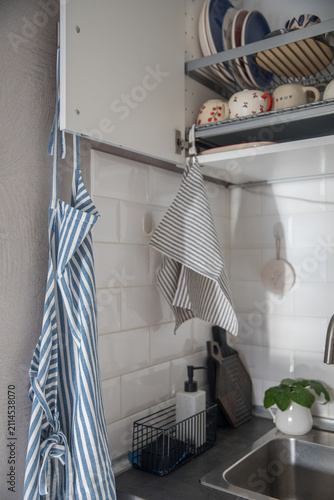 Fotografie A kitchen towel on a cupboard with dishes