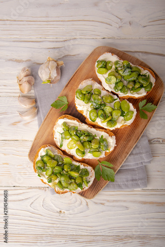 Obraz na płótnie Bruschetta with Fava Beans on Wooden Board