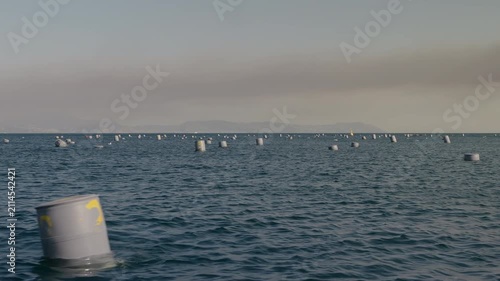 Floating buoys at a mussel farm in the Gulf of Naples, along the Mediterranean coast.