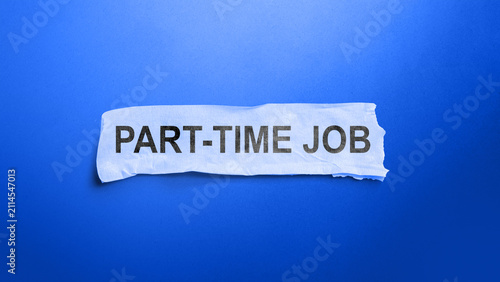 Konstfotografi A torn strip of white paper with the words PART-TIME JOB, placed against a vibrant solid blue background, symbolizing employment opportunities and career search