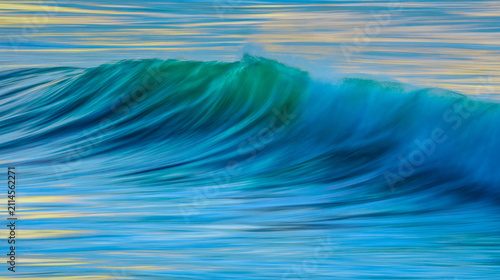 Принти на полотні Ocean wave at sunrise with spray at the crest at slow shutter speed