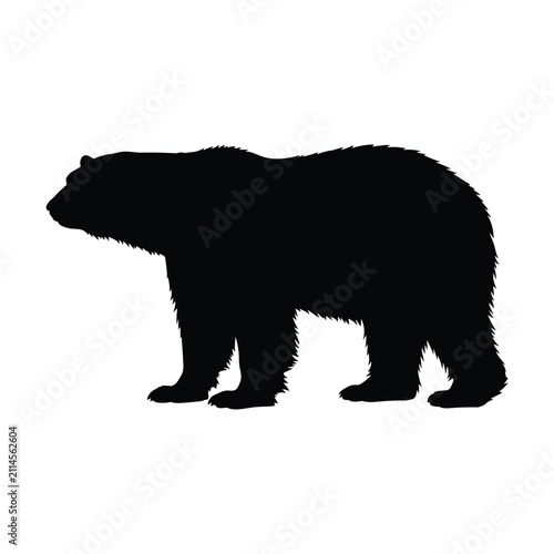 Robust black silhouette of polar bear standing in profile isolated on white background for arctic themed graphic design art