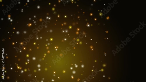 Abstract gold bokeh particles floating on black background