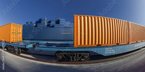 Wide angle perspective of freight container train on rail track curve