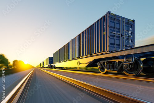Low angle fast motion blur of container train against golden sunset