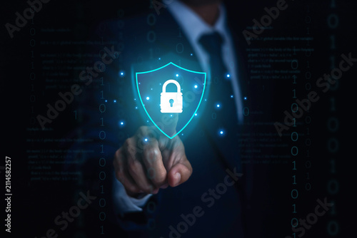 Business professional selecting a digital cybersecurity shield with padlock icon, representing data protection, network security cyber defense, privacy encryption, secure access, information security.