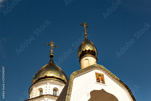 Photography Golden orthodox church domes with crosses against a clear blue sky