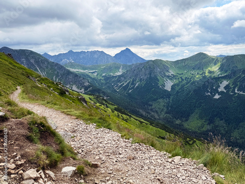 Mountain landscape with hiking trail and green grass in summer. Tatra Mountains in Poland