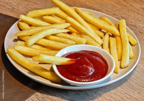 Portion of chips with ketchup. This dish is often served in fast-food restaurants or cafés.
