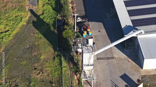 Drone video captures Montrose Quarry in Melbourne from above, showcasing industrial facilities, solar panels, and rugged terrain bathed in vivid morning sunlight. No people are visible.