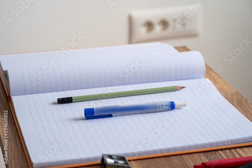 Open blank notebook with school supplies