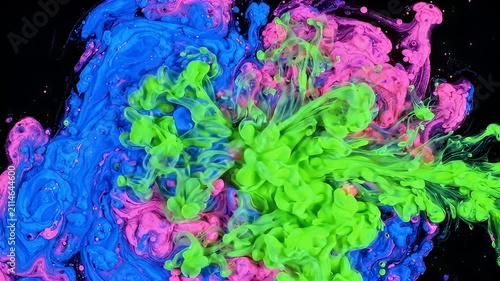 Vivid neon ink clouds in blue pink and green against black