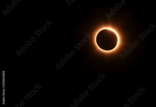 Dramatic total solar eclipse with glowing corona against dark night sky