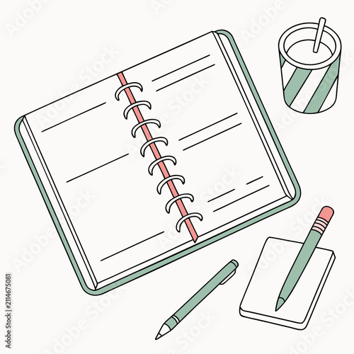 Open planner with pens and drink on a desk setting  