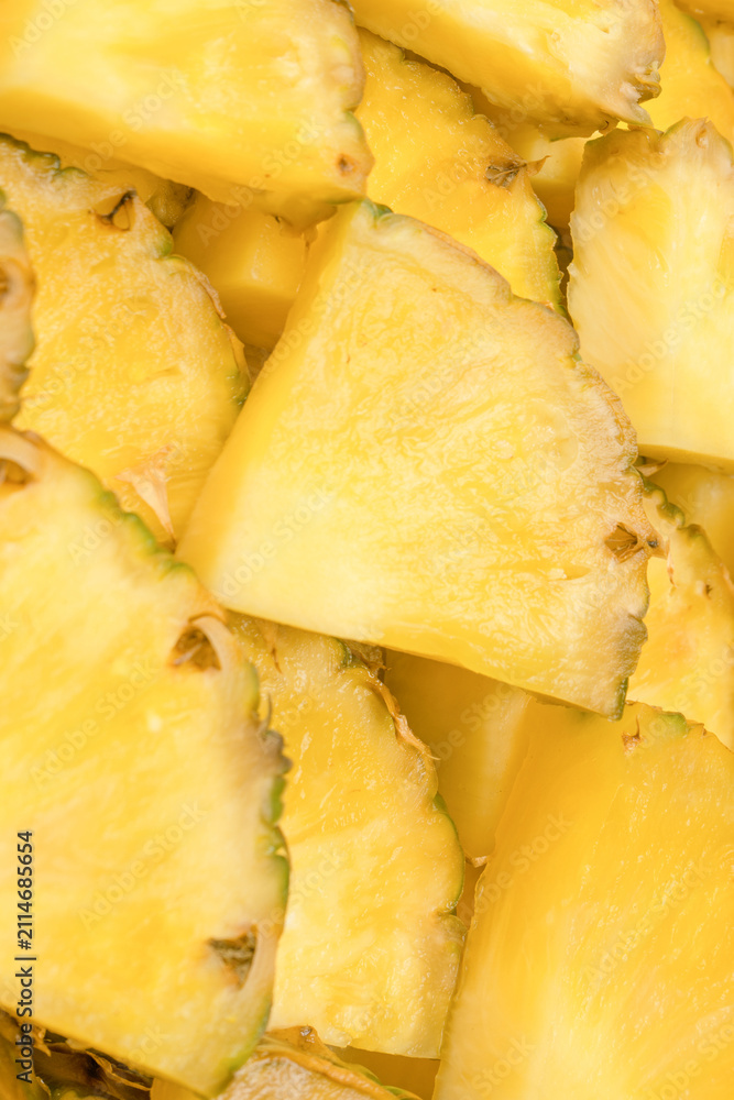 Obraz premium Pineapple juicy yellow slices as a background.
