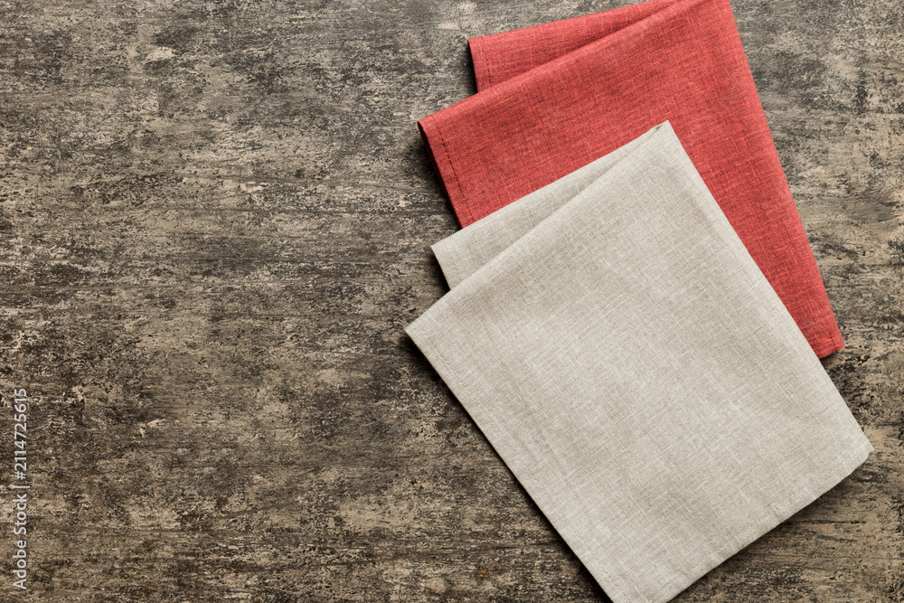 Fototapeta premium top view with gray kitchen napkin isolated on table background. Folded cloth for mockup with copy space, Flat lay. Minimal style
