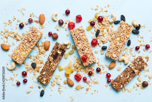 Various granola bars on table background. Cereal granola bars. Superfood breakfast bars with oats, nuts and berries, close up. Superfood concept