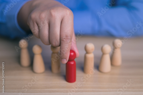Businessman hand choosing red wooden figure from group, Recruitment and human resource management concept.
