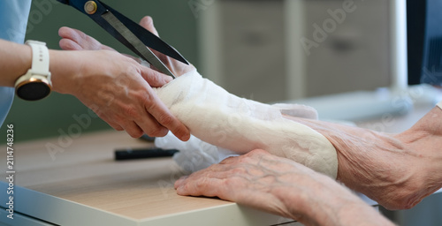 Konstfotografi Close-up splint removal from osteoporosis patient hand in hospital
