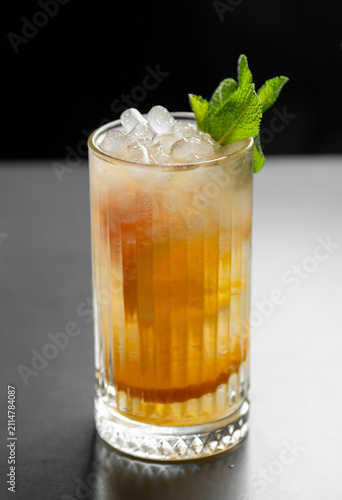 Картината върху платно Cocktail with ice cubes and mint on a black background.