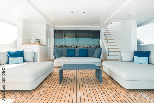 Fotografie Modern Superyacht interior, aft deck lounge, with teak deck, ample loungers for