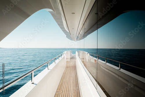 Beautiful detail of a superyacht upper deck corridor reflection on the glass windows, featuring the yacht's architectural design