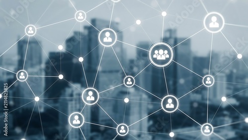 A network of connections representing people and communities overlaid on a city skyline. The interconnected icons symbolize communication, social networking, and urban life