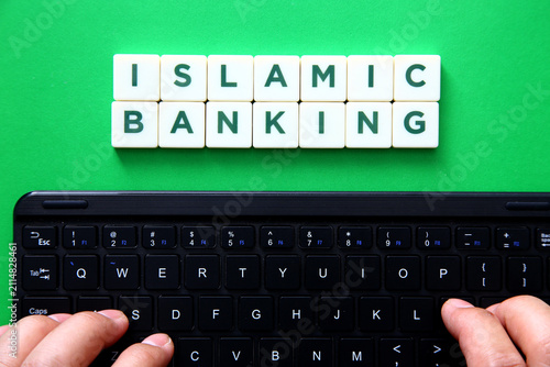 Islamic banking inscription above person typing on keyboard