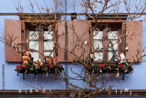 Rustic Christmas window display with bare branches and ornaments in France