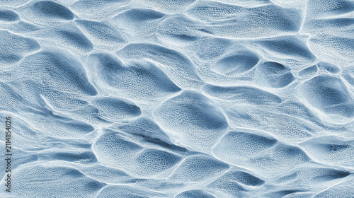 Abstract blue microscopic texture showing undulating organic cellular patterns and deep ridges