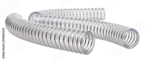 Flexible transparent plastic suction hose with steel wire coil reinforcement isolated on black background for industrial fluid transfer, water pump tube, durable PVC pipe. Technical equipment cutout.