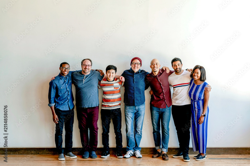 Fototapeta premium Diverse group of smiling men and women standing together indoors
