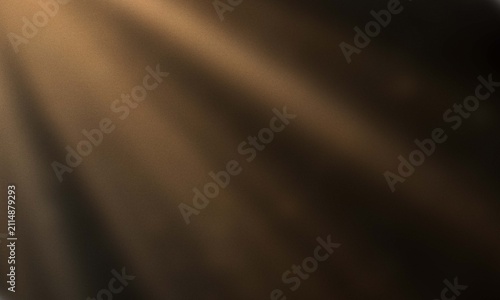 Abstract background with soft golden light rays streaming through dark shadows creating a mysterious and elegant atmosphere