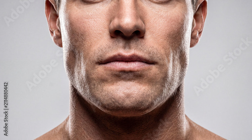 Male strong-willed chin with stubble close-up. Square jaw, brutality, leadership, anthropological features of mandible development, face, physiognomy