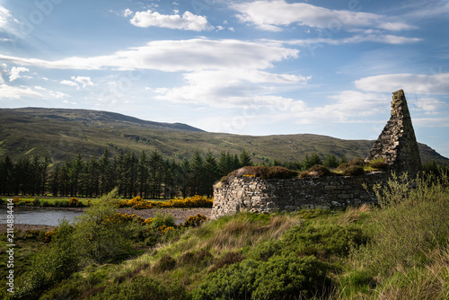 A bright summer, wide angled HDR landscape image of the remains of the Iron Age Broch, Dun Dornaigil in Strath more, Sutherland, Scotland