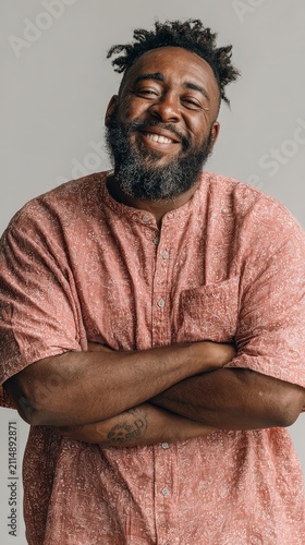 Smiling Black Man with Dreadlocks in Pink Shirt, Arms Crossed – Authentic Joyful Portrait for Lifestyle and Business Use