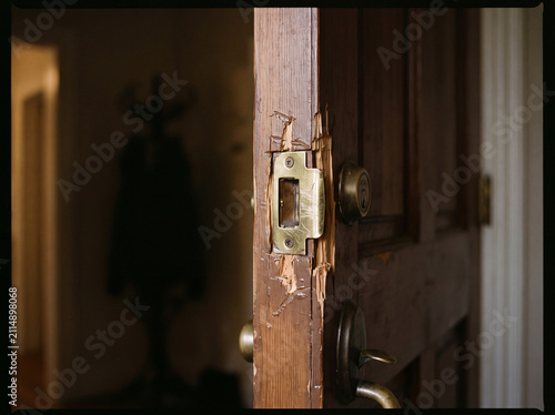Close up of a damaged wooden front door frame after a forced break in attempt at a residential home