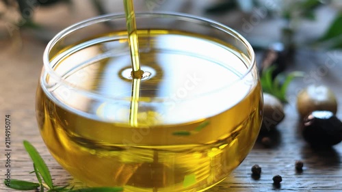 olive oil pouring in a glass bowl	