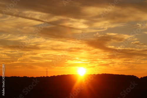 A beautiful golden sunset casting its warm glow over the horizon, painting the sky with vibrant orange and yellow hues