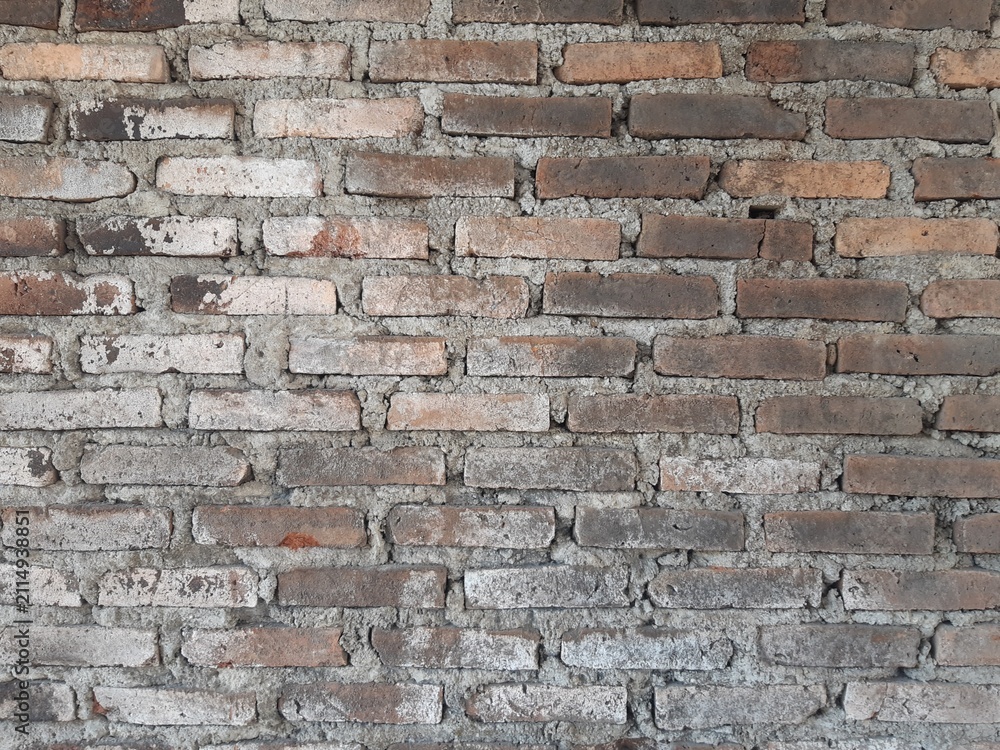 Fototapeta premium old brick wall texture background with weathered cement mortar