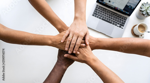 Diverse Team Hands Stacked Together Over Office Desk, Top View